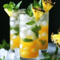 - Fresh pineapple chunks - Fresh mint leaves - Honey or agave syrup - Coconut water - Lime juice - Sparkling water - Ice cubes - Extra mint leaves - Pineapple slice - Vitamin C from pineapple - Hydration from coconut water - Antioxidants from mint The key to a great Minty Pineapple Cooler lies in its fresh ingredients. You’ll need ripe, juicy pineapple chunks for a sweet base. Fresh mint leaves will add a refreshing burst that brightens the drink. Sweetness comes from honey or agave syrup, which you can adjust to your taste. Coconut water brings hydration and a light tropical flavor, while lime juice adds a zesty kick. Don’t forget the sparkling water! It gives the drink that bubbly finish. Ice cubes are a must to keep your cooler chilled and enjoyable. For garnishes, a few extra mint leaves and a slice of pineapple offer a lovely, vibrant touch. These little details enhance the drink's look and make it more fun to enjoy. Nutritionally, this drink is a powerhouse. Pineapple provides a good dose of vitamin C, which is great for your immune system. Coconut water keeps you hydrated, especially during hot summer days. Mint is rich in antioxidants, which may help with digestion and freshening your breath. This Minty Pineapple Cooler is not just a treat; it's a refreshing way to stay healthy and hydrated. For the complete recipe, check the Full Recipe section. To start, gather all your ingredients. In a blender, add the fresh pineapple chunks, mint leaves, honey, coconut water, and lime juice. Blend these ingredients until smooth. If you like your drink less pulpy, strain the mixture. Use a fine mesh sieve to pour it into a pitcher. This makes the drink silky and nice. Next, grab your favorite glasses. Fill each glass halfway with ice cubes. Now, pour the pineapple-mint mixture over the ice. Fill each glass about two-thirds full. To add some fizz, top off each drink with sparkling water. This makes it extra refreshing! To finish, stir each glass gently. This helps mix the flavors without losing the bubbles. For a lovely touch, add garnishes. Place extra mint leaves on top and maybe a slice of pineapple on the rim. These small details make your cooler look great. Enjoy your Minty Pineapple Cooler! For the full recipe, check the section above. To get the best texture in your Minty Pineapple Cooler, blend all the ingredients well. Start with fresh pineapple chunks and mint leaves. Blend until smooth, but if you like a smoother drink, you can strain it using a fine mesh sieve. This helps remove any pulp. When it comes to sweetness, you can adjust as needed. Honey works great, but you can also use agave syrup. Add a little, blend, and taste. If you want it sweeter, add more. Just remember, you can always add, but you can't take away! For the best presentation, choose tall glasses that show off the bright color of your cooler. Fill each glass halfway with ice cubes. Pour the mixture over the ice, then top it off with sparkling water. This gives a nice fizz and makes it refreshing. Pair your Minty Pineapple Cooler with light snacks. Think fresh fruit, veggie sticks, or even chips with a zesty dip. These snacks will balance the drink's sweetness and keep your guests happy. You can change the flavors in your Minty Pineapple Cooler easily. Try adding extra fruits like mango or berries for a fruity twist. This will make each sip unique. Another fun idea is to use flavored sparkling water. Look for options like lime or raspberry to add another layer of taste. This way, you can switch things up each time you make it! {{image_2}} You can give the Minty Pineapple Cooler a tropical twist by adding mango or passion fruit. Both fruits add a rich, sweet flavor. Simply blend in one cup of your chosen fruit along with the other ingredients. This change will make your drink even more fruity and fun. Mango brings a creamy texture, while passion fruit adds a tangy kick. You can mix and match to find your favorite flavor. For a fresh twist, try adding basil or cilantro to your cooler. These herbs can change the drink's flavor profile. Just a handful of leaves will do! Basil gives a sweet, slightly spicy note, while cilantro adds a bright, zesty touch. Blend these herbs with the mint for an herbal explosion. This version is perfect for those who love bold flavors and want to impress their guests. You can easily turn your Minty Pineapple Cooler into a fun cocktail. Adding rum or vodka makes it an adult beverage. Use about 2 ounces of your favorite spirit for each glass. Blend it with the other ingredients to create a refreshing drink. This option is great for summer parties or relaxing evenings. Just remember to drink responsibly and enjoy the delicious flavors! For the full recipe, check out the Minty Pineapple Cooler section. To keep your Minty Pineapple Cooler fresh, use airtight containers. Glass jars or plastic containers work well. Store the cooler in the refrigerator for up to three days. After this time, the flavors may fade, and the drink may separate. If you want to save the cooler for later, freezing is a great option. Pour the mixture into ice cube trays or freezer-safe containers. Leave some space at the top to allow for expansion. When you’re ready to enjoy it, take the cooler out of the freezer and thaw it in the fridge overnight. After refrigerating or freezing, stir the cooler well before serving. Pour it over fresh ice to keep it extra cold. If the mixture has settled, give it a good shake or stir. Add new mint leaves and a slice of pineapple for a fresh look! Yes, you can make this drink ahead of time. To prep, blend the pineapple, mint, honey, coconut water, and lime juice. Pour the mixture into a container and keep it in the fridge. This way, you save time when guests arrive. Just remember to add ice and sparkling water right before serving. This keeps it fresh and fizzy! If you don't have coconut water, use other liquids. Some good choices are: - Fresh orange juice - All-natural lemonade - Regular water with a pinch of salt These options still give a refreshing taste. You can mix and match to find your favorite! To cut the sweetness, here are some easy tricks: - Reduce the honey or agave syrup. - Add extra lime juice for a tangy kick. - Use less sweet coconut water or other liquids. These methods keep the flavor balanced without making it too sugary. You can enjoy the Minty Pineapple Cooler just the way you like it! You learned how to make a refreshing Minty Pineapple Cooler. We covered the ingredients and step-by-step instructions. I shared tips on blending, serving, and customization. You even discovered variations for tropical flavors and an alcoholic twist. Enjoy this drink as a tasty treat or healthy refreshment. With its vibrant flavors and easy preparation, you’ll impress your friends and family. Cheers to staying cool and hydrated!