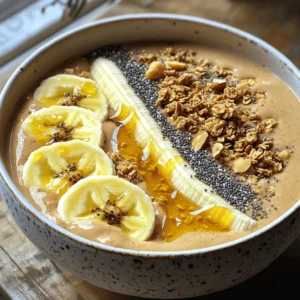 The Peanut Butter Banana Smoothie Bowl is a tasty and easy dish. It blends sweet bananas and creamy peanut butter. You can enjoy it for breakfast or as a snack. This bowl is a mix of flavors and textures. It is also packed with nutrients. Follow this recipe for a quick and healthy meal. - 2 ripe bananas - 1/2 cup creamy peanut butter - 1 cup almond milk (or alternative) - 1 tablespoon honey or maple syrup (optional) - 1/2 teaspoon vanilla extract - 1/4 cup rolled oats - Suggested toppings: sliced banana, granola, chia seeds, crushed nuts, honey drizzle Each ingredient adds unique taste and health benefits. Bananas provide energy and sweetness. Peanut butter adds protein and healthy fats. Almond milk makes it creamy without dairy. Honey or maple syrup gives a touch of sweetness. Rolled oats bring fiber and help keep you full. Toppings like granola and nuts add crunch and taste. This bowl is not just good; it’s also good for you! - Step 1: Blend ingredients together Start by placing one ripe banana, peanut butter, almond milk, honey, vanilla extract, and rolled oats into a blender. Blend on high until the mixture is smooth and creamy. This is where the magic begins! - Step 2: Adjust almond milk for desired thickness If you want a thicker smoothie, add less almond milk. For a thinner consistency, pour in a bit more almond milk. You control the texture of your bowl. - Step 3: Pour into a bowl Once blended, carefully pour the smoothie into your favorite bowl. Look at that creamy goodness! It’s already looking tasty. - Step 4: Add banana slices and toppings Take the second banana and slice it into rounds. Arrange those slices on top of your smoothie bowl. Add your favorite toppings, like granola, chia seeds, and crushed nuts. A drizzle of honey adds the final touch of sweetness. For the full scoop on making this delightful dish, check out the Full Recipe. Enjoy your creation! To get the best peanut butter banana smoothie bowl, start with your blender. I recommend using a high-speed blender for a creamy texture. Make sure to add your liquid first. This helps the blades spin freely and mix well. If your smoothie is too thick, add more almond milk. Start with a little and blend again. You can also add ice cubes for a colder drink. If it's too thin, throw in some rolled oats or more banana. This thickens the mix nicely. Next, let's talk about layers. After pouring the smoothie into your bowl, add the toppings in style. First, place banana slices neatly. Then, sprinkle granola, chia seeds, and crushed nuts. This makes your bowl look great and adds fun textures. A drizzle of honey on top adds a sweet touch. For the best look, use a variety of colors. Bright fruits like berries or kiwi can make your bowl pop. Experiment with different toppings to find your favorite. Each bowl can be a new creation. Enjoy your healthy delight! {{image_2}} You can easily switch up the nut butter in this recipe. Instead of peanut butter, try almond or cashew butter. Both will add a nice twist to the flavor. If you want a creamier base, use coconut milk or oat milk instead of almond milk. Milk choices allow for more taste options. For sweetness, you can skip honey or maple syrup. Use agave syrup or stevia instead. These alternatives can help cut calories while keeping the taste. Toppings can make or break your smoothie bowl! Fresh fruit adds color and taste. Try using berries, kiwi, or mango for a fruity flair. Each fruit brings its own unique flavor and health benefits. Crunchy toppings add texture. You can sprinkle on nuts, seeds, or granola. Each adds a delightful crunch. For an extra flavor boost, consider coconut flakes or cocoa nibs. These small additions can enhance the taste and visual appeal of your bowl. The right toppings make the dish more fun and satisfying. For the full recipe, check out the Peanut Butter Banana Bliss Smoothie Bowl. To keep your peanut butter banana smoothie bowl fresh, follow these tips: - Storing leftover smoothie mixture: If you have extra smoothie left, pour it into an airtight container. Seal it well and keep it in the fridge. Use it within 24 hours for the best taste. - Correct storage of cut fruits for toppings: Slice your fruits just before serving. If you have leftovers, store them in a sealed bag or container. Keep them in the fridge to prevent browning. Use within a day for best flavor and texture. - Recommended timeframes for freshness: Smoothie mixtures taste best fresh. However, if stored right, you can keep them for a day. Toppings like bananas and nuts are best eaten within a few hours for peak crunch and freshness. By following these storage tips, you can enjoy your peanut butter banana smoothie bowl at its best. For the full recipe, check back to the main recipe section. Can I make this smoothie bowl vegan? Yes, you can make this smoothie bowl vegan. Just use plant-based milk like almond or oat milk. Also, skip honey and use maple syrup instead. How can I adjust the recipe for more servings? To adjust for more servings, just multiply the ingredients. For two bowls, use four bananas and one cup of peanut butter. This way, everyone can enjoy it! What are the nutritional benefits of this smoothie bowl? This smoothie bowl is packed with nutrients. Bananas give you potassium, while peanut butter adds protein and healthy fats. Oats provide fiber, which helps with digestion. It’s a great start to your day! Can I freeze bananas for this recipe? Yes, you can freeze bananas! Just peel and slice them before freezing. Frozen bananas make the smoothie bowl extra creamy and cold. It's a fun trick for a refreshing treat. For the full recipe, check out the details above. This blog post showed you how to make a tasty peanut butter banana smoothie bowl. Remember, you need ripe bananas, creamy peanut butter, almond milk, and oats. I shared step-by-step instructions to help you blend the perfect mix. Use my tips to adjust thickness and layer toppings nicely. You can also try different nut butters or toppings for variety. Enjoy this delicious bowl as a healthy option anytime. It’s easy to make, fun to customize, and a great way to eat well!