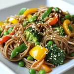 - 200g soba noodles - 1 tablespoon fresh ginger, minced - 3 garlic cloves, minced - 1 bell pepper (red or yellow), sliced - 1 cup broccoli florets - 1 cup snap peas - 2 carrots, julienned - 3 green onions, chopped Soba noodles are key in this dish. They have a nutty taste and firm texture. Fresh ginger gives a warm kick, while garlic adds depth. For veggies, I like bell peppers, broccoli, snap peas, and carrots. They add color and crunch. Feel free to swap or add any veggie you love. - 4 tablespoons soy sauce - 1 tablespoon rice vinegar - 1 tablespoon honey or maple syrup - 2 tablespoons sesame oil The sauce is simple yet packed with flavor. Soy sauce brings saltiness, while rice vinegar adds tang. A touch of honey or maple syrup balances the flavors. Sesame oil gives a rich, nutty finish. It’s the magic that ties everything together. {{ingredient_image_1}} Start by bringing a pot of water to a boil. Make sure you use enough water to allow the noodles to move freely. Once the water is boiling, add 200g of soba noodles. Cook them according to the package instructions. This usually takes about 4-5 minutes. You want the noodles to be al dente, meaning they should be soft but still have a slight bite. After cooking, drain the noodles and rinse them under cold water. This stops the cooking process and keeps them from getting sticky. Set the noodles aside for later. Next, let's make the sauce. In a small bowl, combine 4 tablespoons of soy sauce, 1 tablespoon of rice vinegar, 1 tablespoon of honey or maple syrup, and 1 tablespoon of minced ginger. Whisk the ingredients together until they blend well. This sauce will add a rich flavor to your dish. Set the sauce aside for now so it’s ready when you need it. Now, it’s time to stir-fry! Heat 2 tablespoons of sesame oil in a large skillet or wok over medium-high heat. Once the oil is hot, add 3 minced garlic cloves. Sauté the garlic for about 30 seconds until it is fragrant. Be careful not to burn it. Next, add your vegetables. Toss in 1 sliced bell pepper, 1 cup of broccoli florets, 1 cup of snap peas, and 2 julienned carrots. Stir-fry these veggies for about 5-7 minutes until they are tender yet still crisp. Now, add the cooked soba noodles to the skillet. Pour the prepared sauce over the noodles and vegetables. Toss everything together well, making sure the noodles and veggies are coated in the sauce. Stir-fry for another 2-3 minutes until everything is heated through. Your Ginger Soy Soba Noodle Stir Fry is almost ready! - Ensure noodles are not overcooked: Soba noodles cook quickly. Boil them for just 4-5 minutes. Drain and rinse them in cold water right away. This stops the cooking and keeps them firm. Overcooked noodles can become mushy and lose their bite. - Sauté vegetables correctly: Heat your sesame oil over medium-high heat. When you add garlic, stir it for only 30 seconds. This brings out its flavor without burning it. Add your veggies next, like bell pepper, broccoli, and snap peas. Stir-fry them for 5-7 minutes. They should be tender but still crunchy. - Adjusting sweetness levels: If you prefer a sweeter taste, add more honey or maple syrup to your sauce. Start with a teaspoon more and taste it. You can always add more, but you can’t take it out! - Adding more spices or herbs: For extra flavor, consider adding crushed red pepper flakes for heat or fresh herbs like cilantro for brightness. You can also use a splash of lime juice to brighten the dish. Experiment with flavors until it suits your taste. Pro Tips Use Fresh Ingredients: Fresh vegetables will enhance the flavor and texture of your stir fry. Choose vibrant, seasonal produce for the best results. Don't Overcook the Noodles: Soba noodles can become mushy if overcooked. Aim for al dente to maintain a pleasant texture. Customize Your Veggies: Feel free to add or substitute other vegetables like mushrooms, zucchini, or bok choy based on your preferences or what's in season. Adjust the Sauce: Taste the sauce before adding it to the stir fry. You can adjust the sweetness or saltiness by adding more honey or soy sauce as needed. {{image_2}} You can switch up the veggies in this stir fry. Feel free to try zucchini, mushrooms, or even bok choy. Each brings a new flavor and texture. If you want something crunchy, add some bell peppers or snap peas. For a heartier option, add sweet potato or kale. Mix and match to find your favorite combo! Want to make this dish more filling? Add protein! Tofu is a great choice for a plant-based meal. It soaks up the sauce and adds creaminess. If you prefer meat, chicken or shrimp work well too. Cook them first, then add the veggies and noodles. This way, everything cooks evenly and blends nicely. If you need a gluten-free meal, no worries! Use gluten-free soy sauce instead of regular soy sauce. Also, try gluten-free noodles like rice noodles or quinoa noodles. They still taste great with the ginger soy sauce. You won’t miss the gluten at all! To store your Ginger Soy Soba Noodle Stir Fry, place leftovers in an airtight container. Make sure it cools down before sealing. This keeps out moisture and helps it last longer. Store it in the fridge for up to three days. Reheating this dish is simple. Just add a splash of water to keep it moist, and heat it on the stove or microwave. If you want to freeze the stir fry, let it cool completely first. Then, use a freezer-safe container or bag. Remove as much air as possible to prevent freezer burn. You can freeze it for up to three months. When you’re ready to eat, thaw it in the fridge overnight. To reheat, you can use a skillet over medium heat, adding a little water if needed. For the best taste, enjoy your stir fry within three days if refrigerated. If frozen, it’s best to eat within three months. After that, the flavors may fade, but it will still be safe to eat. Keeping it sealed well helps maintain the taste and texture. Always check for any signs of spoilage before eating leftovers. To spice up your dish, add red pepper flakes or sriracha. These options give a nice kick. If you prefer milder flavors, skip the heat or use sweet bell peppers. You can also add more honey for sweetness. Yes, you can use other noodles if you want. Try rice noodles or udon for a different taste. Just follow the cooking instructions on the package. Whole wheat pasta is another good choice for a healthier option. This recipe is great for meal prep! You can cook the noodles and veggies in advance. Store them in airtight containers in the fridge. They will stay fresh for up to four days. Reheat in a pan with a splash of water to bring back the flavor. This blog post shows you how to make a tasty stir-fry. You learned about key ingredients like soba noodles and fresh veggies. I provided step-by-step instructions for cooking and mixing everything together. Tips helped you avoid common cooking mistakes and added flavor. You can even vary your meal with different veggies or proteins. In the end, this stir-fry is easy to customize and store. With these skills, you can create delicious, healthy meals every time. Enjoy cooking!
