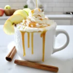 - 2 cups milk (dairy or non-dairy) - 1/2 cup brewed strong coffee or espresso - 1/4 cup apple cider - 2 tablespoons caramel sauce (plus extra for drizzling) - 1/4 teaspoon ground cinnamon - 1/4 teaspoon ground nutmeg - Whipped cream (for topping) - Apple slices (for garnish) - Cinnamon stick (optional, for garnish) To make a delicious Caramel Apple Spice Latte, you need just a few simple ingredients. Start with two cups of milk, which can be dairy or non-dairy. Choose what you like best! Next, brew half a cup of strong coffee or espresso. This gives your drink a rich flavor. You will also need a quarter cup of apple cider. The cider adds a sweet and fruity taste. For sweetness, use two tablespoons of caramel sauce. Don’t forget to save some for drizzling on top! You’ll also add a quarter teaspoon of ground cinnamon and a quarter teaspoon of ground nutmeg for warmth. Top your latte with whipped cream for creaminess. Finally, garnish with apple slices and a cinnamon stick if you want a fancy touch. - Dairy alternatives (almond, oat, etc.) - Sweetener options - Flavor enhancements (vanilla extract, pumpkin spice) Feel free to mix things up! You can use almond or oat milk if you prefer non-dairy options. For sweeteners, try honey or maple syrup. Want more flavor? Add a splash of vanilla extract or a pinch of pumpkin spice. These little changes can make your latte even more special! To make the best Caramel Apple Spice Latte, start with the right heating technique. Heat the milk and apple cider in a small saucepan over medium heat. Stir it gently. You want it warm, not boiling. Boiling can change the flavor and texture. Next, brew your strong coffee or espresso. Use a method you enjoy, like a French press or an espresso machine. The stronger the coffee, the better it will balance the sweet flavors in the latte. Now it’s time to assemble your drink. Pour the brewed coffee into a large mug. Slowly add the warm milk and cider mixture over the coffee. This pouring method helps layer the flavors nicely. Stir gently to blend everything together. Top your latte with a generous dollop of whipped cream. This adds creaminess and makes it look inviting. Drizzle extra caramel sauce on top. For the final touch, garnish with apple slices and a cinnamon stick if you like. Choosing the right mug can enhance your latte experience. I recommend using a large, clear mug to show off the beautiful layers. It makes the drink look as good as it tastes. For snacks or desserts, pair your latte with apple pie or cinnamon cookies. These treats complement the drink’s flavors well. Enjoy this cozy drink by a warm fire or on a chilly day for the best experience! To make your Caramel Apple Spice Latte pop, focus on the spices. Use fresh ground cinnamon and nutmeg. Fresh spices add a depth that pre-ground ones can't match. Mix a pinch of allspice or ground ginger for a kick. For a creamier texture, use whole milk or a rich non-dairy option like oat milk. Heat the milk gently to avoid boiling. This keeps it frothy and smooth. You can also whisk the milk while heating. This adds air and makes it creamier. One big mistake is overheating the milk. This can make it taste burnt and ruin your latte. Heat it slowly and watch closely. Another mistake is skipping the spices. Cinnamon and nutmeg bring warmth and flavor. Without them, your drink can taste flat. Don’t skip these key ingredients! You can easily make this drink iced or blended. For an iced version, chill the coffee and milk mixture. Pour it over ice and enjoy a refreshing twist. If you want a blended drink, add ice to your blender with the latte mix. Blend until smooth for a creamy, icy treat. You can also adjust sweetness levels. If you like it sweeter, add more caramel sauce. You can try maple syrup or honey for different flavors too. {{image_2}} You can play with the Caramel Apple Spice Latte for fun seasonal flavors. For autumn, try adding pumpkin puree. Just mix in a few tablespoons with the warm milk and cider. It gives a cozy, sweet taste that warms you right up. During the holidays, think peppermint or gingerbread. Swap a bit of caramel sauce for peppermint syrup. This twist creates a festive drink that feels like a warm hug. Or add gingerbread spice in place of cinnamon. Each option brings a new twist that makes your drink unique. Not a coffee drinker? No worries! You can make a caffeine-free version easily. Just skip the coffee and increase the apple cider to 1/2 cup. This keeps the drink warm and sweet without the jitters. You can also create an apple cider drink. Simply heat apple cider with milk and spices. This gives you a lovely drink that captures the essence of the Caramel Apple Spice Latte without any coffee. Want to adjust the recipe? It’s simple! For one cup, use 1 cup of milk, 2 tablespoons of apple cider, and 1 tablespoon of caramel sauce. This makes a perfect single serving. If you’re hosting a crowd, multiply the recipe. For a group of four, use 4 cups of milk, 2 cups of coffee, and 1 cup of cider. This way, everyone can enjoy a warm cup of this cozy drink. To store leftover syrup or cider, place it in a sealed jar. Keep it in the fridge. It will stay fresh for about a week. For milk, always keep it in the coldest part of your fridge. If you choose non-dairy milk, store it the same way. Almond, oat, and soy milk all last long when sealed tight. Yes, you can prepare components in advance. You can make the spiced milk and cider mix and store it in the fridge. Brew your coffee or espresso fresh when you're ready to serve. When reheating the milk mixture, do it slowly on low heat. This keeps all the flavors intact. Your prepared latte can last in the fridge for up to two days. After that, it may start to lose flavor and quality. Signs it’s no longer good to drink include a sour smell or off taste. Always trust your senses before enjoying your drink! You can brew coffee without a machine using simple methods. One option is the French press. Just add coffee grounds and hot water, then let it steep. Another way is to use a pour-over dripper. Place a filter, add coffee, and pour hot water slowly. You can also use instant coffee. Just mix it with hot water for a quick fix. Each method gives you a rich coffee flavor for your latte. Yes, you can make this latte vegan! Just swap dairy milk for almond, oat, or soy milk. For the caramel sauce, look for a vegan brand or make your own using coconut cream and sugar. These simple swaps keep the taste while making it plant-based. You can enjoy this cozy drink without dairy. This latte has several benefits. Apple cider contains antioxidants that help fight free radicals. Cinnamon can aid digestion and may lower blood sugar levels. If you use non-dairy milk, it can be lower in calories and fat. The whipped cream adds a bit of sweetness, but you can skip it for a lighter option. Overall, this drink can be a tasty treat with some healthy perks. You can find this latte at popular coffee chains like Starbucks and Dunkin'. They usually offer it during the fall season. The drink is often part of their special menu, so be sure to check if it’s available. Local coffee shops may also have their own version, especially around autumn. It's always nice to enjoy this drink while out with friends. In this blog post, we explored how to make a delicious Caramel Apple Spice Latte. We covered key ingredients, preparation steps, and ways to customize the drink. Remember to experiment with flavors and toppings for your perfect latte. Enjoying a warm, spiced drink can bring comfort and joy. Now, you're ready to create your own tasty versions! Share your favorite tweaks or look for new ways to enjoy this seasonal favorite.