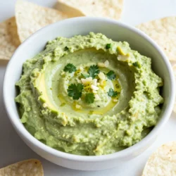 - 2 ripe avocados - 1 lime (juice and zest) - 1/2 cup Greek yogurt - Optional ingredients for spice You can swap Greek yogurt for sour cream or silken tofu. Each gives a nice creamy texture. To find ripe avocados, look for ones that are slightly soft when you press them. They should not be mushy or hard. If you prefer a low-fat option, use low-fat yogurt instead. For a dairy-free dip, use a plant-based yogurt. {{ingredient_image_1}} - First, I take 2 ripe avocados. I slice them open and remove the pits. I scoop the flesh into a medium bowl. Then, I mash the avocados with a fork. I want them creamy but still a bit chunky. - Next, I add 1/2 cup of Greek yogurt to the mashed avocado. I mix it well until both are smooth and combined. This makes the dip rich and creamy. - Now, I squeeze in the juice of 1 lime. I also add the lime zest for extra flavor. Then, I include 1 minced clove of garlic and a minced jalapeño, if I want some heat. Lastly, I sprinkle in 1/4 teaspoon of ground cumin. I stir everything until it's well mixed. - I taste the dip and add salt and pepper to my liking. This step is key to making the flavors pop. - Once seasoned, I transfer the dip to a serving bowl. I love to sprinkle fresh chopped cilantro on top. This adds a bright color and fresh taste. - I serve this dip with tortilla chips, fresh veggies, or even on sandwiches. It's a hit every time! To mash avocados effectively, use a fork. Press down on the avocado gently. You want it creamy but with some chunks. Avoid a puree for better texture. If you want it creamier, add more Greek yogurt. This makes the dip smooth and rich. To change the flavor, consider adding spices. A pinch of cayenne gives heat. You can also try smoked paprika for a smoky taste. This dip pairs well with other dips, like salsa or hummus. The mix of flavors keeps your snack exciting. For a perfect dip experience, serve with tortilla chips or fresh veggies. You can also use it on sandwiches or wraps. For plating, use a nice bowl and sprinkle cilantro on top. This adds color and makes it look fresh. Pro Tips Choose Ripe Avocados: Ensure your avocados are ripe for the creamiest texture. They should yield slightly to gentle pressure when squeezed. Fresh Lime Juice: Always use fresh lime juice instead of bottled for a brighter, more vibrant flavor in your dip. Customize the Spice Level: Adjust the amount of jalapeño based on your heat preference. For a milder dip, omit it or use less. Perfect Pairings: This dip pairs wonderfully with tortilla chips, but also try it on sandwiches or as a topping for grilled meats. {{image_2}} You can make this dip vegan by swapping Greek yogurt for plant-based yogurt. Almond or coconut yogurt works well. Just be sure to pick a plain, unsweetened version. This keeps the creamy texture while making it dairy-free. Enjoy the same great taste without the dairy! If you like heat, try adding more jalapeño or a dash of sriracha. Start with a small amount and taste as you go. This way, you can control the spice level. Remember, fresh jalapeños can have varying heat, so adjust to your liking! For extra flavor, consider adding fresh herbs. Chopped dill or green onions can brighten the dip. Mix these in after you combine the other ingredients. They add a nice crunch and depth to each bite. Don’t be afraid to experiment with flavors! To keep your creamy avocado lime dip fresh, store it in an airtight container. Press plastic wrap directly onto the dip's surface to cut off air. This helps slow down browning. Always use a clean spoon when serving. This keeps germs out and maintains flavor. This dip lasts about 3 days in the fridge. If you see any browning, just stir it up. The flavor will still taste great. However, for best quality, eat it within two days. You can freeze avocado dip, but its texture may change. To freeze, scoop the dip into a freezer-safe container. Leave some space at the top. This allows for expansion. To defrost, place it in the fridge overnight. Stir it well before serving. If it seems too thick, mix in a little yogurt or lime juice. Enjoy your dip again! To add spice, include more jalapeño. You can also use hot sauce. Start with a small amount and taste as you go. This way, you can control the heat. Yes, you can make this dip a few hours early. Just cover it tightly with plastic wrap to keep it fresh. I suggest making it no more than a day ahead. Serve this dip with tortilla chips or fresh veggie sticks. It also goes well on sandwiches or tacos. You can even use it as a spread for wraps. To prevent browning, add lime juice after mashing the avocados. You can also press plastic wrap directly against the dip before sealing it. This limits air contact. In this post, we explored how to make a tasty Creamy Avocado Lime Dip. We covered the key ingredients, from ripe avocados to Greek yogurt, and offered tips for measurement and substitutions. You learned step-by-step instructions for preparation and serving that help you impress guests. Remember, you can customize this dip with spices or vegan options. With proper storage, your leftovers will stay fresh. Dive into this easy recipe and enjoy a flavorful dip that everyone will love.