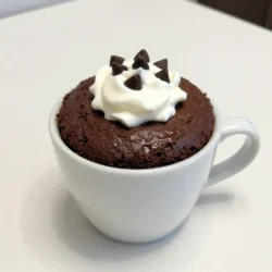 To make your chocolate fudge mug cake, gather these simple ingredients: - 4 tablespoons all-purpose flour - 4 tablespoons granulated sugar - 2 tablespoons unsweetened cocoa powder - 1/8 teaspoon baking powder - A pinch of salt - 3 tablespoons milk (or non-dairy milk) - 2 tablespoons vegetable oil (or melted butter) - 1/4 teaspoon vanilla extract - 2 tablespoons chocolate chips (optional for extra fudginess) Each ingredient plays a key role in creating a rich and moist cake. The all-purpose flour gives structure, while sugar adds sweetness. Cocoa powder gives that deep chocolate flavor. Baking powder makes the cake rise, and salt balances the sweetness. You can customize your mug cake with milk or a non-dairy alternative. The vegetable oil or melted butter keeps it moist. Vanilla extract enhances the flavor. If you want a gooey treat, toss in chocolate chips. Make sure to measure each ingredient carefully. This ensures you get the best texture and taste. The fun part is that you can easily swap ingredients based on what you have at home. Each choice can change your cake in a unique way! {{ingredient_image_1}} - Mixing the dry ingredients In a large microwave-safe mug, add 4 tablespoons of all-purpose flour, 4 tablespoons of granulated sugar, 2 tablespoons of unsweetened cocoa powder, 1/8 teaspoon of baking powder, and a pinch of salt. Stir well until everything is combined. This mix gives your cake a light and fluffy base. - Adding wet ingredients Now, pour in 3 tablespoons of milk and 2 tablespoons of vegetable oil. Add 1/4 teaspoon of vanilla extract for flavor. Mix these wet ingredients into the dry ones. Stir until the batter is smooth and free of lumps. This step is key for a good texture. - Incorporating chocolate chips If you want extra fudginess, now is the time to fold in 2 tablespoons of chocolate chips. Make sure they are evenly mixed throughout the batter. This adds little bursts of chocolate flavor to every bite. - Microwaving the cake Place the mug in the microwave and cook on high for about 1 minute and 30 seconds. Cooking time may vary based on your microwave's wattage. Watch the cake rise; it should look set in the center and still moist. - Checking doneness After microwaving, check if the cake is done. It should be firm but not dry. If it needs more time, microwave in 10-second bursts until it is perfect. Once done, let the mug cake cool for a minute before you dig in. Enjoy your delicious treat! To get a moist texture in your mug cake, use fresh ingredients. Old flour can dry out your cake. When you mix the wet and dry ingredients, stir gently. This keeps air in the batter. If you overmix, your cake may turn out tough. Adjusting the microwave time is key. Most microwaves are different. My microwave cooks this cake in about 1 minute and 30 seconds. If yours is more powerful, start with 1 minute. Keep an eye on it. The cake should rise and look set, but still moist. One common mistake is overmixing the batter. Mix just until combined. This helps keep the cake light and fluffy. Another issue is using too much flour. Always measure carefully. Too much flour makes the cake dry and dense. Stick to the recipe for the best results. Pro Tips Use a larger mug: A larger mug allows the cake to rise without spilling over, ensuring an even cook. Check microwave wattage: Microwaves vary in power; adjust the cooking time based on your appliance for perfect results. Add a pinch of espresso powder: This can enhance the chocolate flavor, making your mug cake even more decadent. Experiment with toppings: Try adding nuts, fruit, or flavored whipped cream for a personalized touch to your mug cake. {{image_2}} You can change some ingredients in your chocolate fudge mug cake. For a gluten-free option, try using almond flour or a gluten-free blend. They work well and keep the cake moist. If you want to make it dairy-free, use almond milk or coconut milk instead of regular milk. You can also switch the vegetable oil for melted coconut oil. Want to add a twist? Toss in some nuts or dried fruit. Walnuts or pecans give a nice crunch. Dried cherries or raisins add sweetness. You can also use different extracts to change the flavor. Almond extract gives a nice nutty touch, while mint extract adds a refreshing taste. Try these options to create your perfect mug cake! To store leftover cake, let it cool down first. Then, cover the mug with plastic wrap. You can also transfer it to an airtight container. This keeps the cake fresh. Avoid leaving it open to the air, as it will dry out. When you want to eat it again, reheating is easy. Just pop the mug back in the microwave. Heat it for about 15 to 30 seconds. Check if it is warm enough. If not, add a few more seconds. The cake lasts about 2 days at room temperature. If you place it in the fridge, it can stay fresh for about a week. Just remember, the longer it sits, the drier it may become. Can I make this recipe without a microwave? Yes, you can! You can bake the mug cake in a regular oven. Preheat your oven to 350°F (175°C). Pour the batter into an oven-safe mug. Bake for about 15 to 20 minutes. Check if it’s done by inserting a toothpick. If it comes out clean, it's ready. How do I make multiple servings? To make more than one mug cake, just multiply the ingredients. Use the same amounts for each mug. You can mix the batter in a bowl first. Then, pour equal amounts into each mug. Cook in batches if your microwave is small. Can I double the recipe in a larger mug? Yes, you can double the recipe if your mug is big enough. Just remember that cooking time may change. Start with 2 to 3 minutes and check for doneness. The cake should rise and be set in the middle. Is it possible to use less sugar? Absolutely! You can reduce the sugar by a tablespoon or two. This will still give you a tasty cake, but it may taste less sweet. You can also add a bit of fruit or chocolate chips for natural sweetness. This blog post guided you through making a quick and tasty mug cake. We covered the key ingredients needed, mixing methods, cooking steps, and tips to get the best texture. You learned how to customize your cake and store it properly. Remember, it’s all about having fun and experimenting with flavors. Make this cake your own, and enjoy each bite!